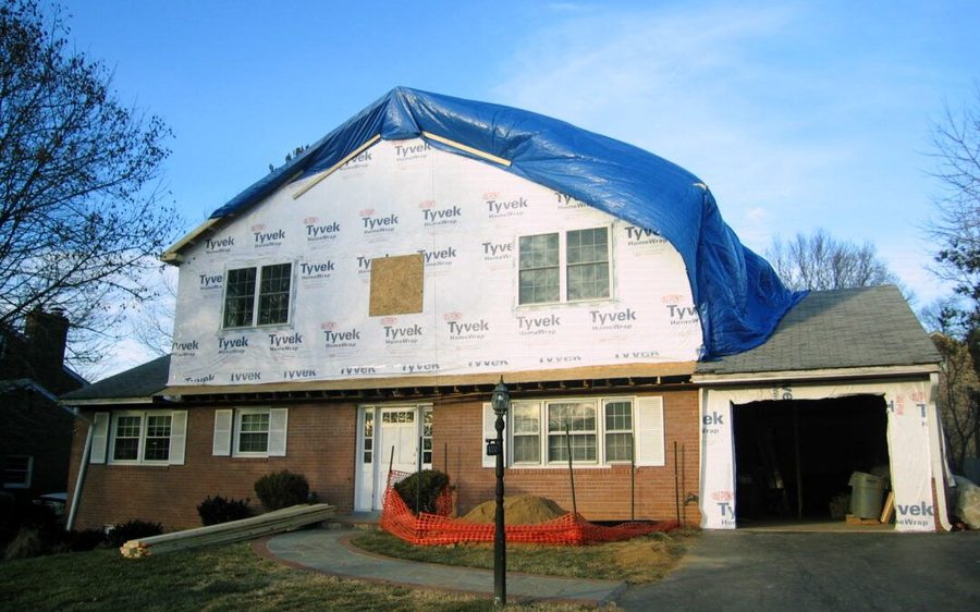 Two-story home addition with siding and gable roof